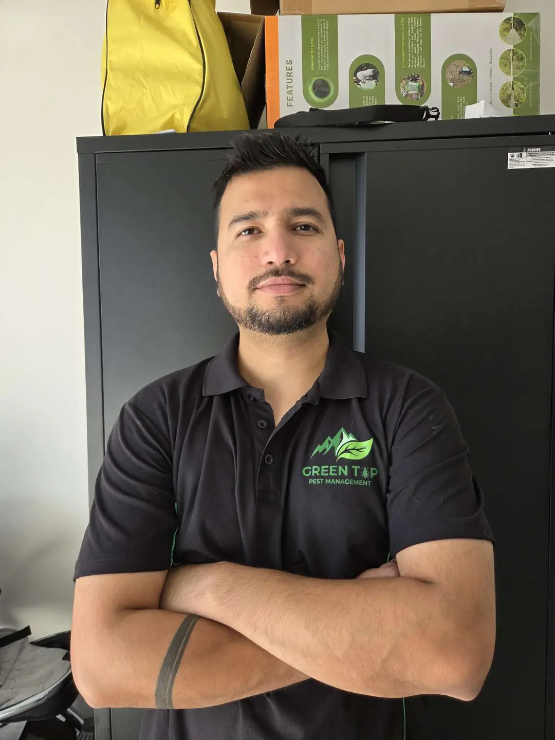 Prajj, founder of Green Top Pest Management, in a Green Top uniform